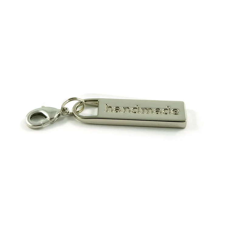 Drager m/ lås nickel rektangeld text HANDMADE